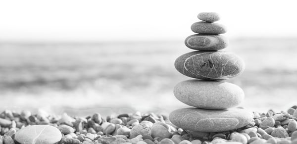 rocks balanced by the water's edge